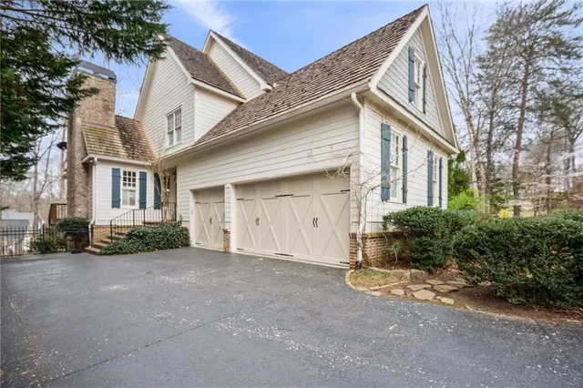 an aerial view of house with yard and mountain view in back