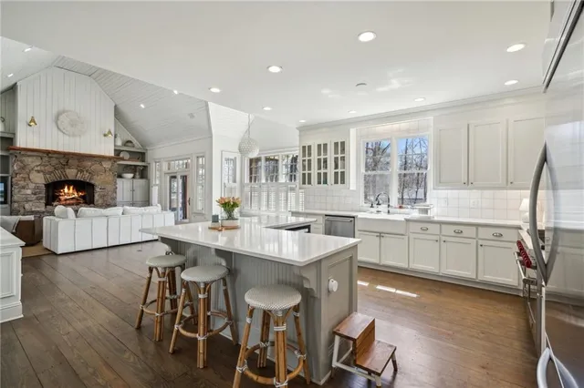 a kitchen with stainless steel appliances white cabinets and a refrigerator