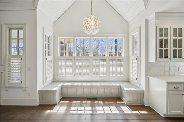 a view of an entryway with wooden floor and a front door