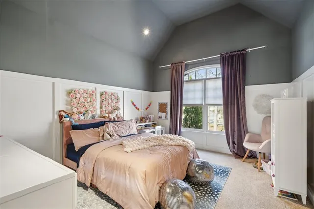 a bedroom with a bed and a potted plant