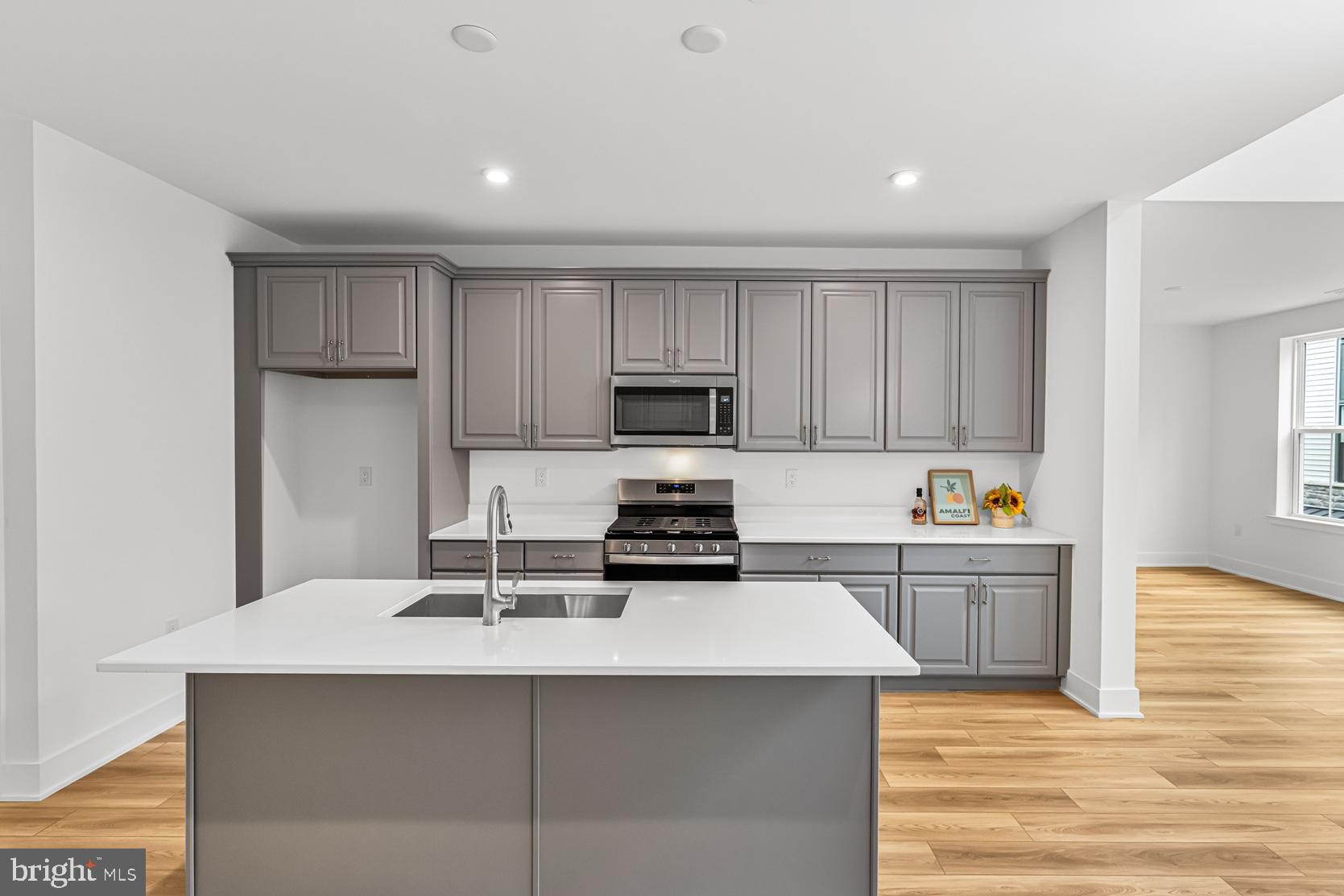 10206 Donatello Drive Princeton, NJ 08540 - Photo 7 of 30 a kitchen with a sink a stove and cabinets
