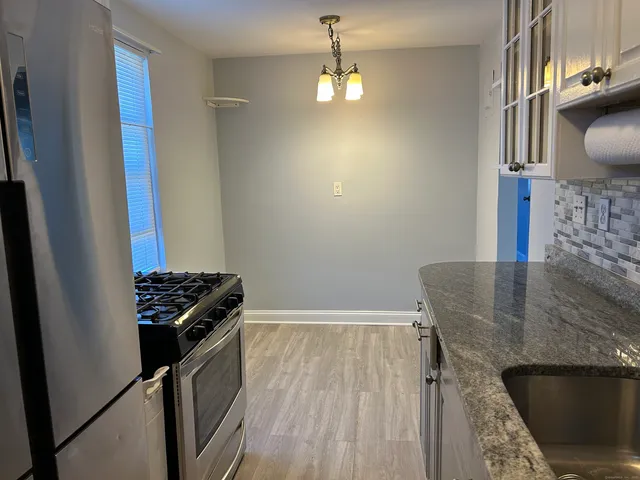 a view of a kitchen from the stairs