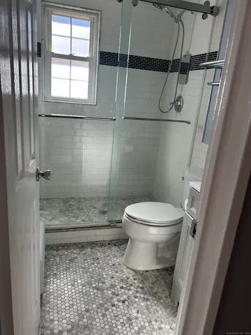 a bathroom with a toilet and a shower