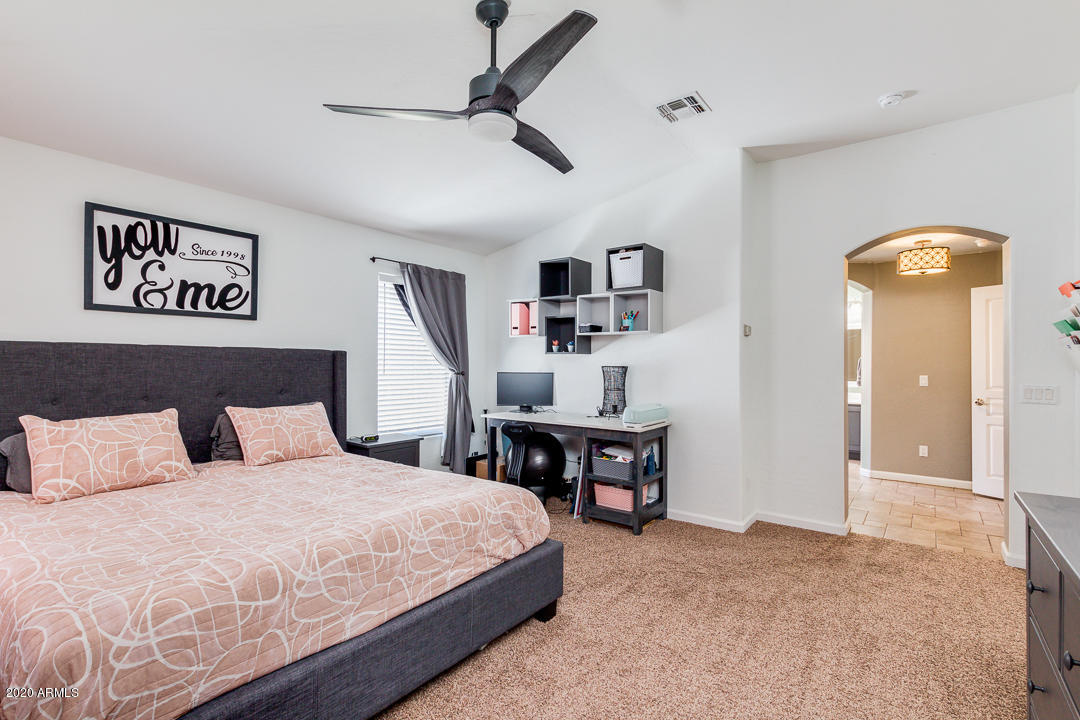 3788 South Martingale Road Gilbert, AZ 85297 - Photo 18 of 46 a bedroom with a bed and a chandelier