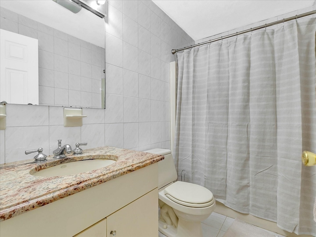 51 Walnut Street Saugus, MA 01906 - Photo 13 of 42 a bathroom with a granite countertop sink and a toilet