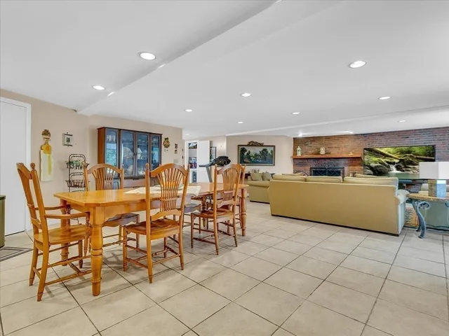 an empty room with wooden floor chandelier fan and windows