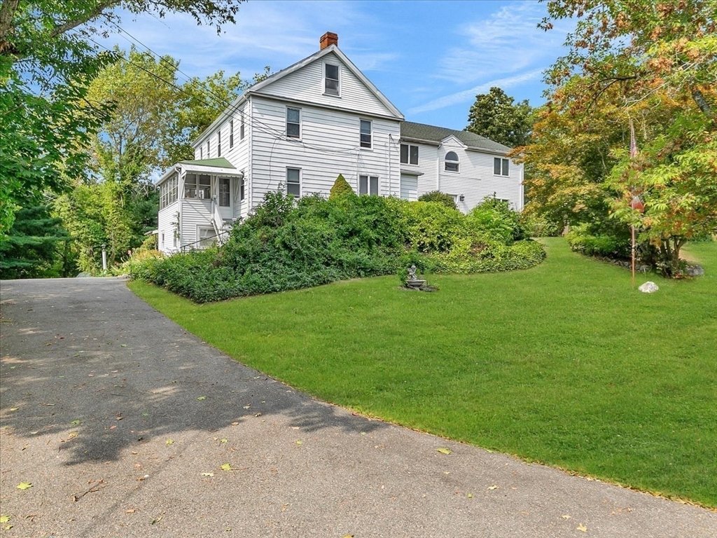 51 Walnut Street Saugus, MA 01906 - Photo 19 of 42 a white house that has a small yard with large trees