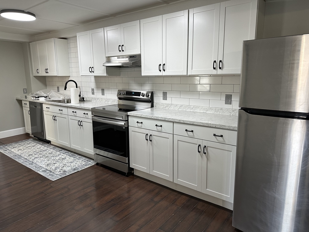 51 Walnut Street Saugus, MA 01906 - Photo 27 of 42 a kitchen with stainless steel appliances granite countertop a refrigerator sink and cabinets