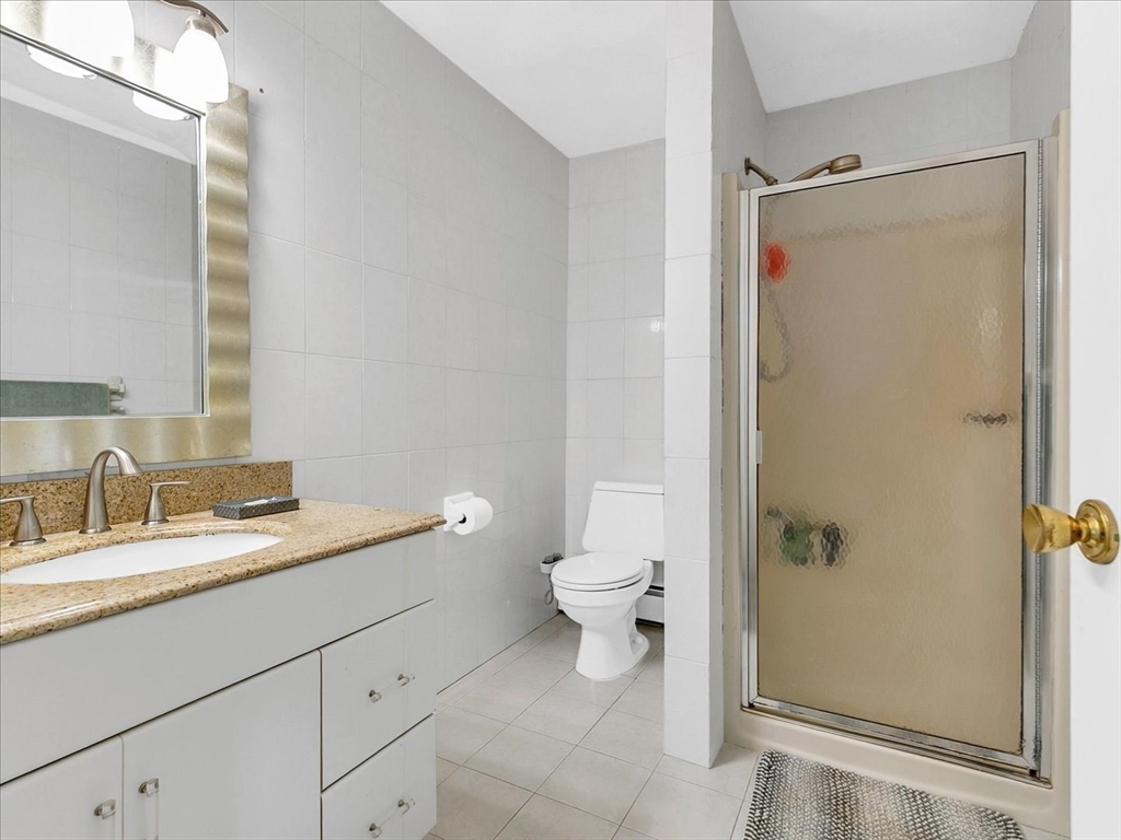 51 Walnut Street Saugus, MA 01906 - Photo 6 of 42 a bathroom with a granite countertop sink toilet and shower