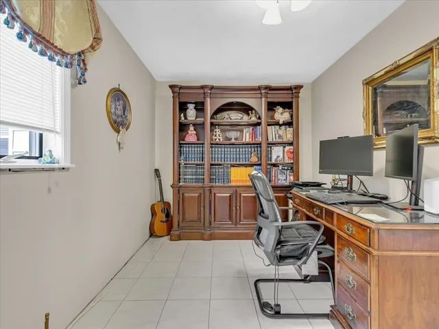 a living room with furniture and a mirror