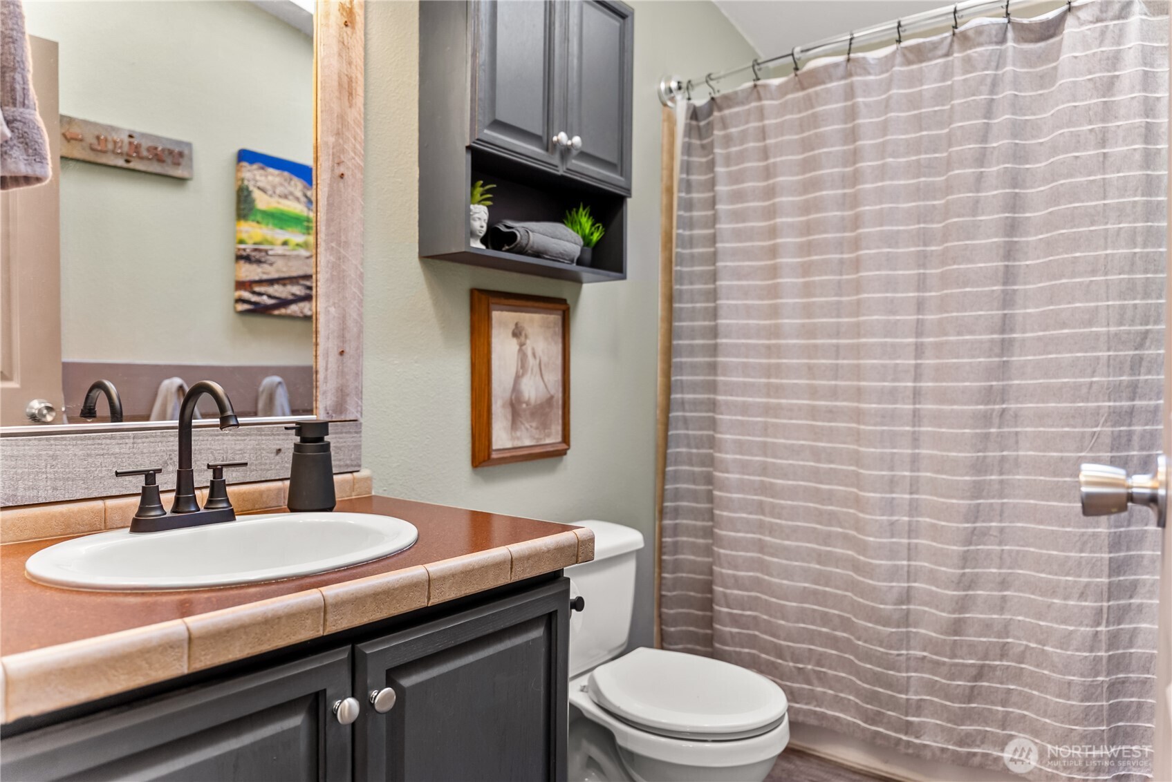 24 Lookout Trail Riverside, WA 98849 - Photo 21 of 39 a bathroom with a granite countertop toilet sink and mirror