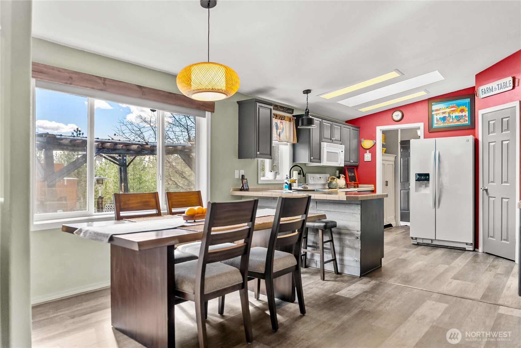 24 Lookout Trail Riverside, WA 98849 - Photo 5 of 39 a dining area with stainless steel appliances granite countertop a table chairs and a refrigerator