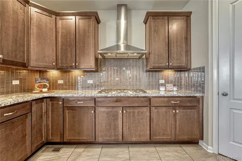 a kitchen with stainless steel appliances granite countertop a sink and cabinets