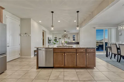 a spacious kitchen with stainless steel appliances granite countertop a refrigerator and a sink