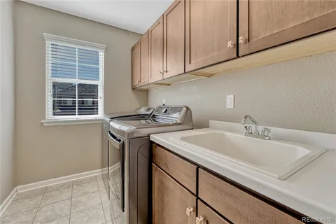 a utility room with sink dryer and washer