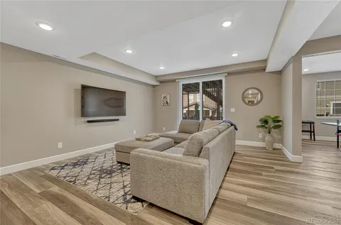 a living room with furniture and wooden floor