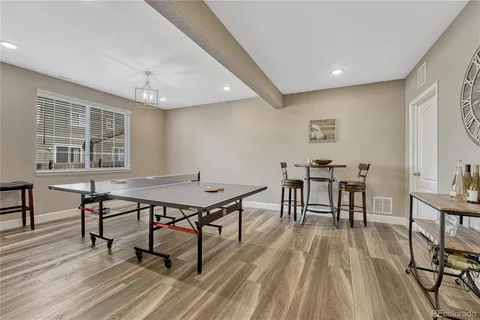 a view of a workspace with furniture window and wooden floor