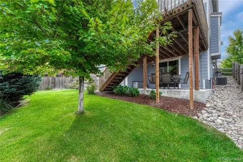 a view of an house with backyard space and garden