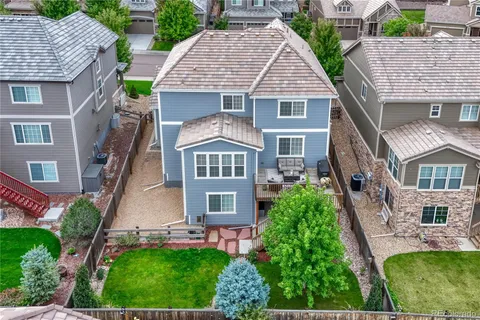an aerial view of a house with a yard