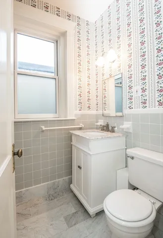 a bathroom with a granite countertop toilet a sink and a shower