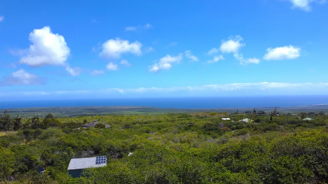 an aerial view of a houses with a yard