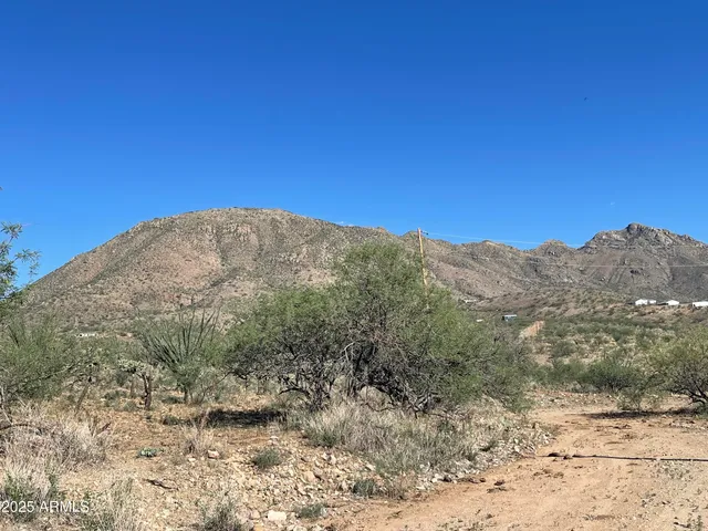 a view of a mountain range with a lush green hillside
