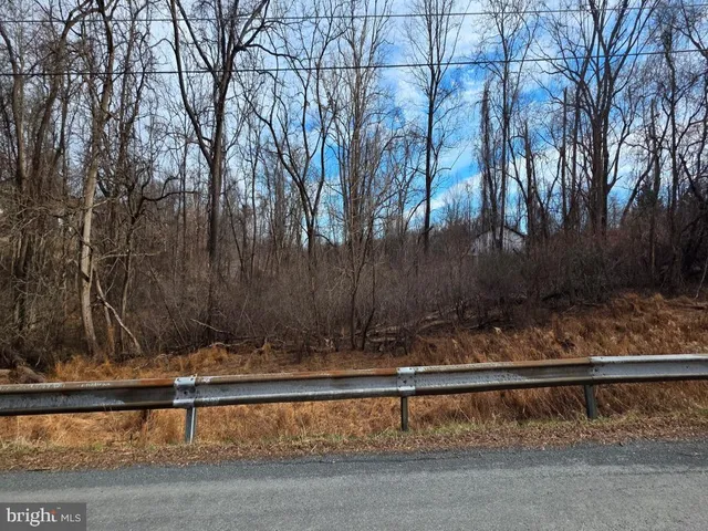 a view of wooden fence and trees