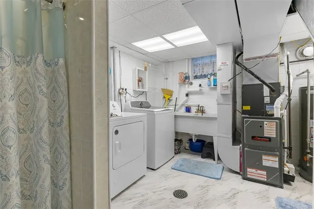 a room with water heater and a cabinets