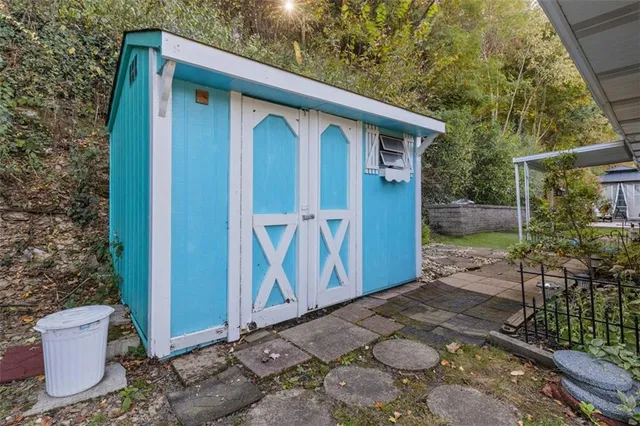 a view of a small house with backyard