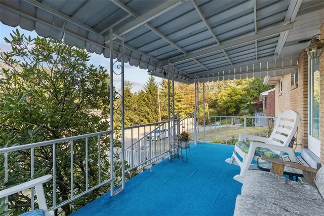 a view of a chairs and table in patio with wooden fence
