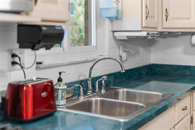 a kitchen with a sink and a microwave