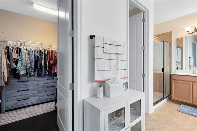 a view of walk in closet and bathroom