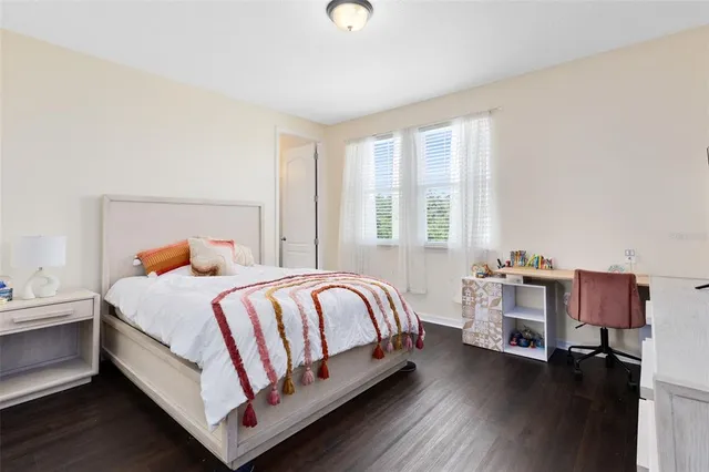 a bed room with a bed and a chair