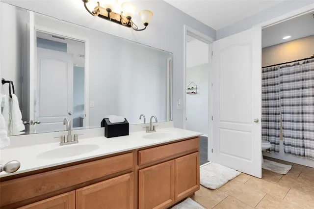 a bathroom with a double vanity sink and a mirror