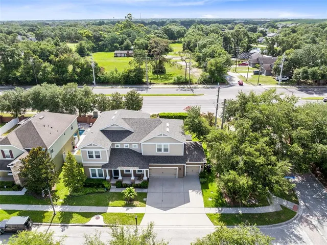 an aerial view of a house with a big yard