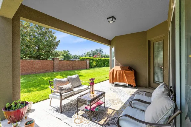 a view of a house with backyard and sitting area