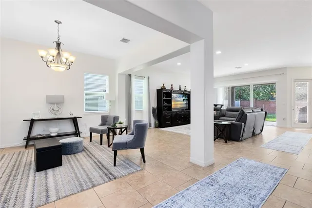 a living room with furniture and kitchen view