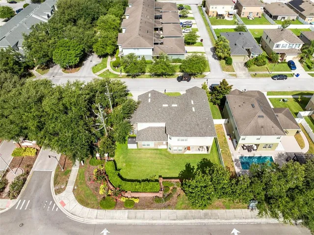 an aerial view of a house with swimming pool patio and outdoor seating
