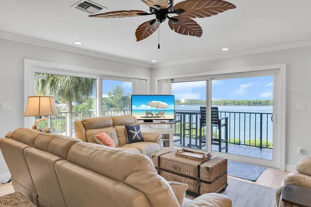 a living room with furniture fireplace and a large window