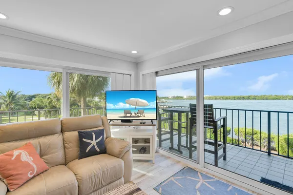 a kitchen with granite countertop a sink a stove and a microwave with wooden floor
