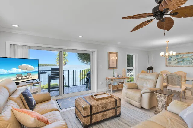 a living room with furniture ceiling fan and a rug