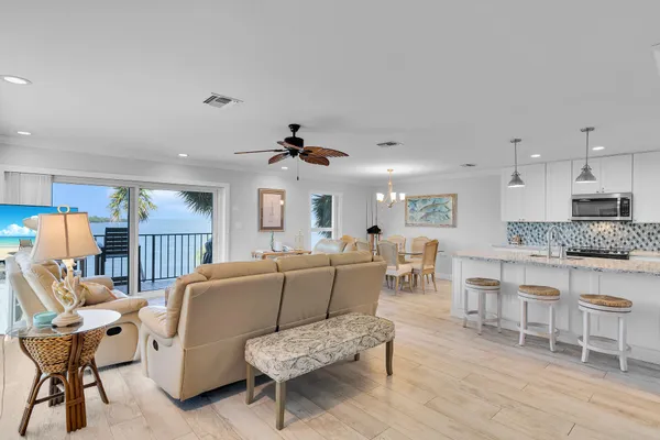 a bedroom with a bed and large windows