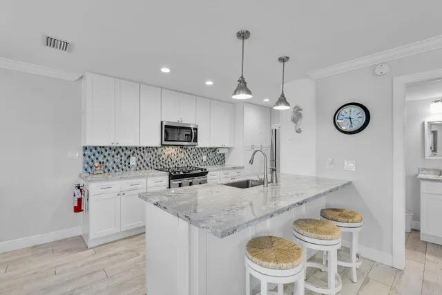 a kitchen with a table chairs and a clock