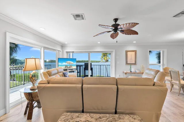 a living room with furniture a ceiling fan and a window