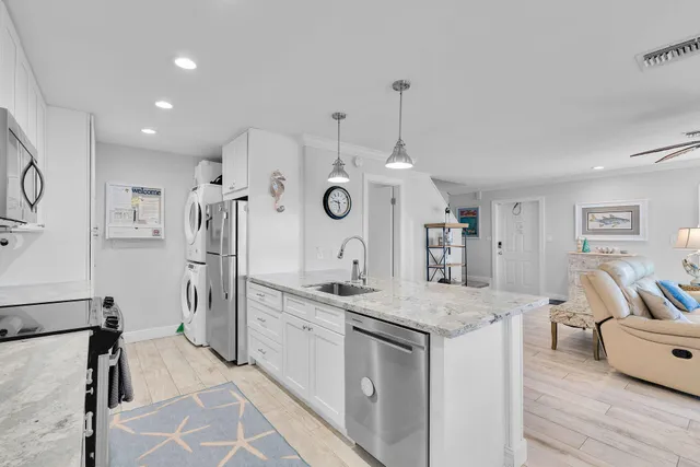a view of a kitchen center island and living room