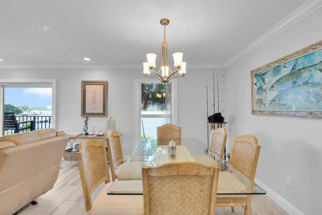 a living room with furniture a chandelier and a mirror