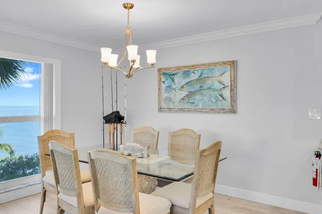 a dining room with furniture a chandelier and wooden floor