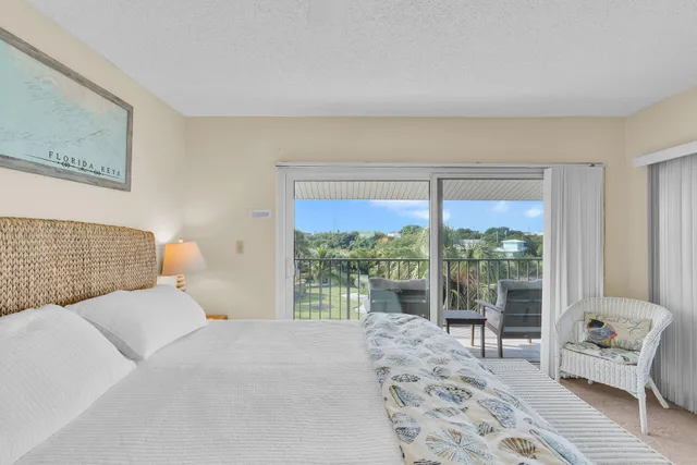 a bedroom with a bed and glass window