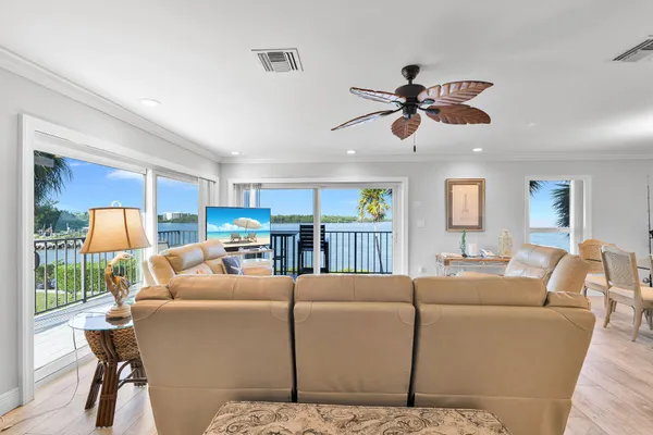 front view of house with a yard and potted plants