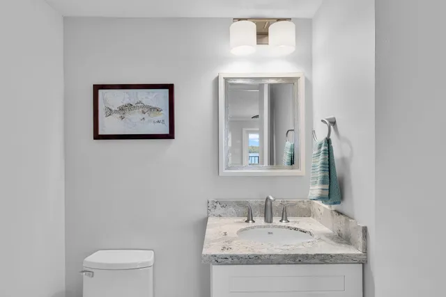 an aerial view of a house with a yard and tennis court